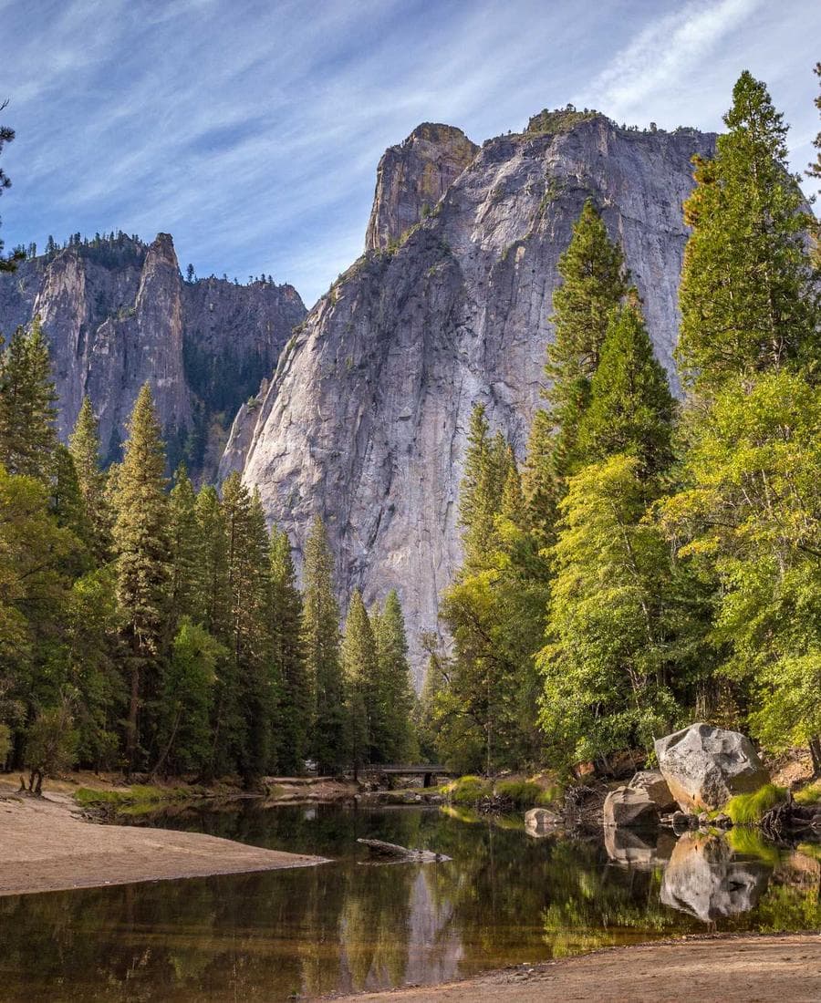 Granite cliffs above a river and pines