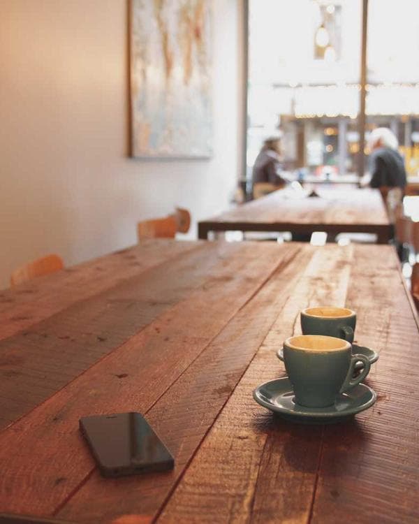 Two coffee cups on a café table